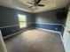 Comfortable bedroom with neutral carpet, tray ceiling, and blue and gray walls at 18805 Nettleton St, Orlando, FL 32833