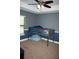 Cozy bedroom with a bed and a beanbag chair, featuring a fan and a window for natural light and ventilation at 18805 Nettleton St, Orlando, FL 32833