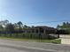 Charming one-story home with a well-maintained lawn, black wooden fence, and gated driveway at 18805 Nettleton St, Orlando, FL 32833