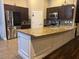 Spacious kitchen featuring granite countertops, stainless steel appliances, and dark wood cabinets at 18805 Nettleton St, Orlando, FL 32833