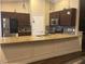 Modern kitchen showcasing granite countertops, stainless steel appliances, and dark wood cabinets at 18805 Nettleton St, Orlando, FL 32833