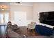 Spacious living room with a large TV, comfortable seating, and elegant design, perfect for entertaining guests at 18805 Nettleton St, Orlando, FL 32833