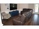 Comfortable living room with a large brown leather sofa, accent chair, and entertainment center, perfect for relaxation at 18805 Nettleton St, Orlando, FL 32833