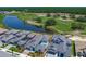 Aerial view of property showcasing a private pool, lush landscaping, and tranquil views of the adjacent pond and golf course at 235 Hampton Loop, Davenport, FL 33837