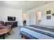 Modern bedroom features a comfortable sitting area, and an ensuite bathroom at 235 Hampton Loop, Davenport, FL 33837