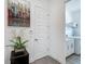 Bright hallway leads to a laundry room, accented with modern decor at 235 Hampton Loop, Davenport, FL 33837