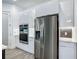 Sleek modern kitchen featuring stainless steel appliances, minimalist cabinets, and stylish tile backsplash accents at 235 Hampton Loop, Davenport, FL 33837