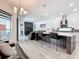 Open concept living room with a kitchen island, dark wood floors, a decorative fireplace, and modern furnishings at 235 Hampton Loop, Davenport, FL 33837