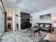 Comfortable living room featuring modern décor, built-in shelving, dark wood accents, and stylish furnishings at 235 Hampton Loop, Davenport, FL 33837