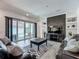 Stylish living room featuring a modern fireplace, built-in shelving, and sliding glass doors to the pool area at 235 Hampton Loop, Davenport, FL 33837