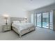 Bright main bedroom with direct access to the pool area, showcasing a serene and luxurious retreat at 235 Hampton Loop, Davenport, FL 33837