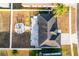 Aerial shot of a backyard featuring a patio, hot tub, fire pit, and full fencing at 2520 Jasmine Trace Dr, Kissimmee, FL 34758