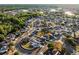 Bird's-eye view of a community with houses, green spaces, and curved streets near a lake at 2520 Jasmine Trace Dr, Kissimmee, FL 34758