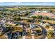 Wide aerial view of a neighborhood with tree-lined streets, lakes, and nearby amenities at 2520 Jasmine Trace Dr, Kissimmee, FL 34758