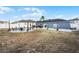 Expansive backyard showcases a fire pit area, an outdoor kitchen, and a hammock; ideal for outdoor living at 2520 Jasmine Trace Dr, Kissimmee, FL 34758