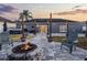 Paver patio features an outdoor kitchen, a fire pit area, and a hot tub; ideal for relaxation and social gatherings at 2520 Jasmine Trace Dr, Kissimmee, FL 34758