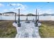 Backyard features a paver patio with a charming fire pit area and string lights, creating an inviting atmosphere at 2520 Jasmine Trace Dr, Kissimmee, FL 34758