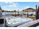 Large backyard featuring a hot tub, outdoor kitchen, a fire pit area, and a hammock at 2520 Jasmine Trace Dr, Kissimmee, FL 34758