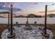 Backyard features a charming fire pit, chairs, decorative string lights, and stylish paver patio, perfect for outdoor entertaining at 2520 Jasmine Trace Dr, Kissimmee, FL 34758