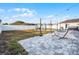 Large backyard features a paver patio with a fire pit, outdoor kitchen, and a hammock; perfect for entertainment at 2520 Jasmine Trace Dr, Kissimmee, FL 34758