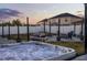 Backyard with hot tub, grill, string lights, and seating area for outdoor entertaining at 2520 Jasmine Trace Dr, Kissimmee, FL 34758
