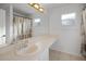 Bright bathroom with a large mirror, elongated vanity, and shower-tub combination at 2520 Jasmine Trace Dr, Kissimmee, FL 34758
