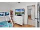 This bedroom showcases a TV on a dresser and is adjacent to another room with tile flooring at 2520 Jasmine Trace Dr, Kissimmee, FL 34758