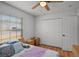 This bedroom features a closet, two nightstands, and hardwood flooring at 2520 Jasmine Trace Dr, Kissimmee, FL 34758