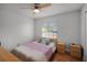 This bedroom features a window, two nightstands, and hard wood flooring at 2520 Jasmine Trace Dr, Kissimmee, FL 34758