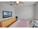 This bedroom features a TV, a dresser, and hard wood flooring at 2520 Jasmine Trace Dr, Kissimmee, FL 34758