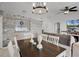 Dining area with wood table, white chairs, view into living room, and backyard view at 2520 Jasmine Trace Dr, Kissimmee, FL 34758