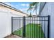 Backyard dog run secured with a black iron fence featuring low-maintenance artificial turf at 2520 Jasmine Trace Dr, Kissimmee, FL 34758
