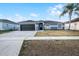 Charming single-story home with a spacious driveway and an attractive, neutral exterior paint scheme at 2520 Jasmine Trace Dr, Kissimmee, FL 34758