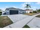 Attractive home featuring a dark garage door, neutral paint, and a spacious driveway at 2520 Jasmine Trace Dr, Kissimmee, FL 34758