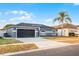 Attractive home featuring a dark garage door, neutral paint, and a spacious driveway at 2520 Jasmine Trace Dr, Kissimmee, FL 34758
