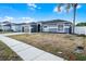Attractive single-story home featuring a dark garage door, neutral paint, and a well-manicured lawn at 2520 Jasmine Trace Dr, Kissimmee, FL 34758