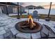 Inviting backyard fire pit with stone surround, perfect for cozy outdoor evenings and gatherings at 2520 Jasmine Trace Dr, Kissimmee, FL 34758
