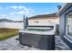 Relax in the backyard hot tub on paver patio under sunny skies; perfect for unwinding after a long day at 2520 Jasmine Trace Dr, Kissimmee, FL 34758