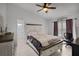 This main bedroom features white walls, tile flooring, and a ceiling fan at 2520 Jasmine Trace Dr, Kissimmee, FL 34758