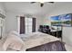 Bright view of this main bedroom featuring an office desk, and a TV at 2520 Jasmine Trace Dr, Kissimmee, FL 34758