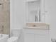 Bathroom featuring a white vanity with tan countertop, toilet, tub, tiled shower and modern fixtures at 2845 Pierr St, Davenport, FL 33837