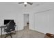 Bedroom with a computer desk, chair, a closet with a double door, and a fan at 2845 Pierr St, Davenport, FL 33837
