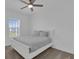 A well-lit bedroom featuring neutral carpet, a ceiling fan, and a view from a window at 2845 Pierr St, Davenport, FL 33837