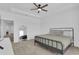 A cozy bedroom with neutral carpet, a metal bed frame, ceiling fan, and a full-length mirror at 2845 Pierr St, Davenport, FL 33837