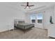 Bright bedroom featuring a metal bed frame, ceiling fan, and two windows letting in ample natural light at 2845 Pierr St, Davenport, FL 33837