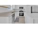 Bright kitchen featuring stainless steel appliances, white cabinets, and quartz countertops at 2845 Pierr St, Davenport, FL 33837