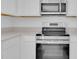 Modern kitchen featuring stainless steel appliances, including a range and microwave at 2845 Pierr St, Davenport, FL 33837