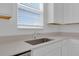 Close up of bright kitchen with stainless steel sink and a window providing natural light at 2845 Pierr St, Davenport, FL 33837