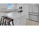 Bright kitchen with stainless steel appliances, white cabinets, island with seating at 2845 Pierr St, Davenport, FL 33837