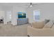 Comfortable living room features a TV, furniture, and carpeted floors at 2845 Pierr St, Davenport, FL 33837